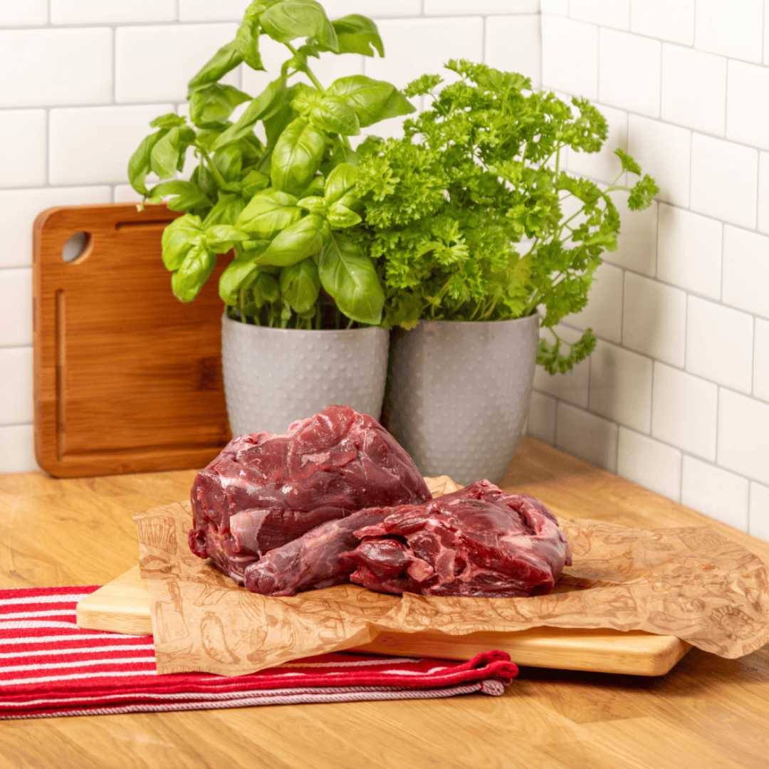 The Dogs Butcher Muntjac Deer Meaty Neck displayed on a chopping board